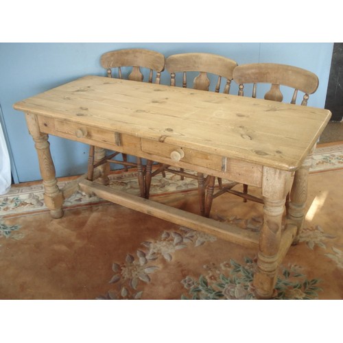 45 - An antique pine Farmhouse Table with two frieze drawers raised on turned supports united by H-stretc... 