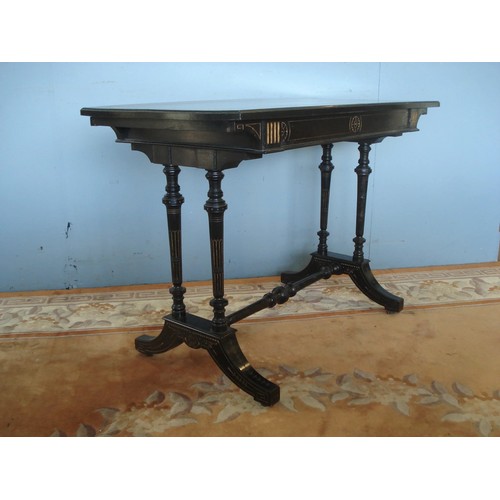 18 - A Victorian ebonised Side Table with walnut inlay, raised on turned supports united by H-stretcher a... 