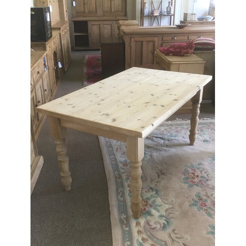 79 - A pine farmhouse Kitchen Table raised on turned supports 5ft W x 2ft 6in H x 3ft D
