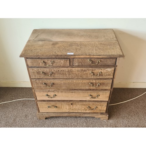 64 - An 18th Century stripped oak Chest of two short over four long graduated drawers raised on bracket f... 