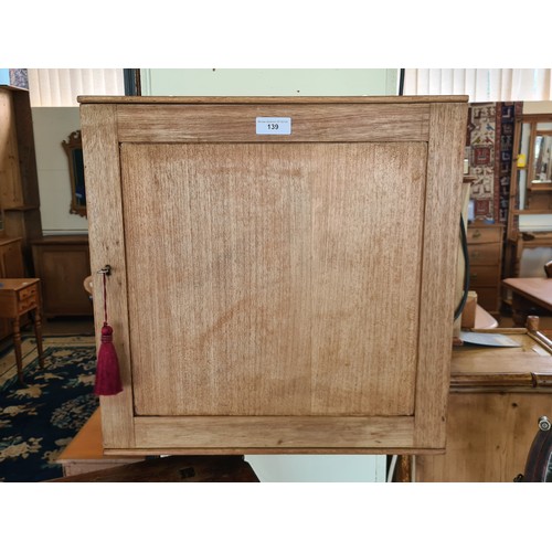 139 - A stripped mahogany Wall Cupboard fitted single door enclosing pigeon hole interior 1ft 8in W x 1ft ... 