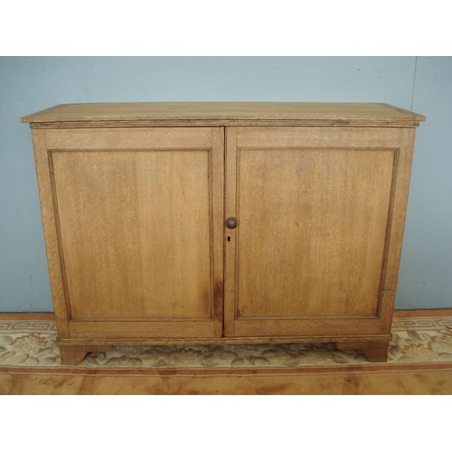 5 - An antique oak two door Cupboard enclosing pigeon hole interior raised on bracket feet 4ft 1in W x 2... 