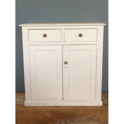 7 - An antique white painted pine Cupboard fitted two frieze drawers above pair of fielded panel doors 3... 