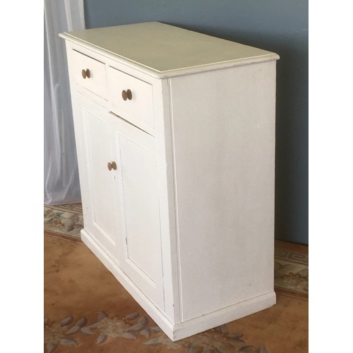 7 - An antique white painted pine Cupboard fitted two frieze drawers above pair of fielded panel doors 3... 