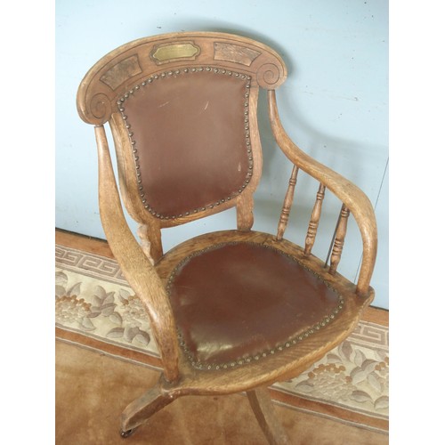 38 - An antique ash Swivel Elbow Chair with engraved brass plaque 'to a Reverend, rotates, height adjusta... 