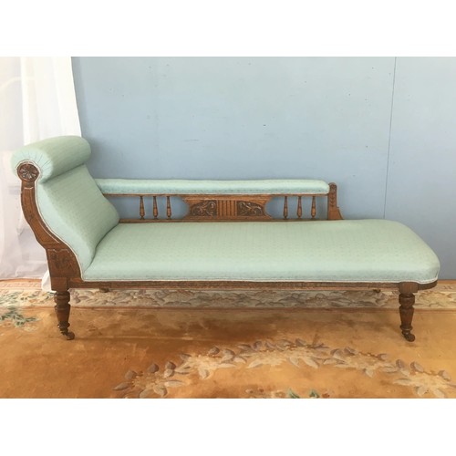 40 - A Victorian oak framed Chaise Lounge with pale blue upholstery raised on turned supports 5ft 6in L x... 