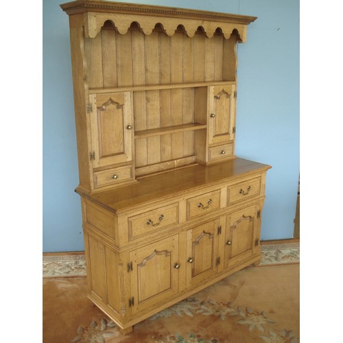 84 - An oak Dresser and Rack by Titchmarsh & Goodwin, the rack fiited pair of fielded cupboard doors and ... 