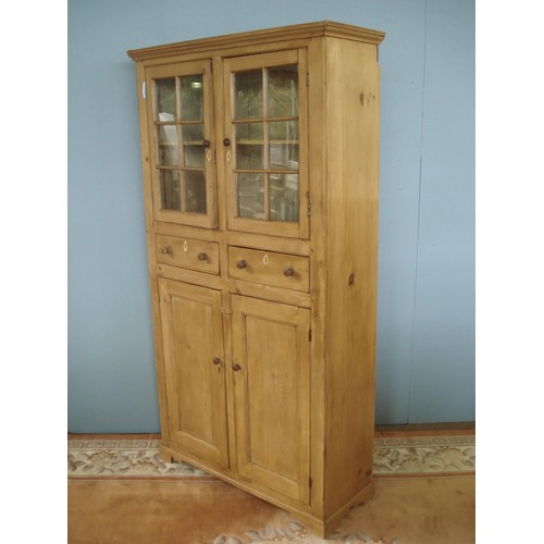 86 - A George III pine Cupboard fitted pair of glazed doors above two drawers and pair of fielded panel d... 