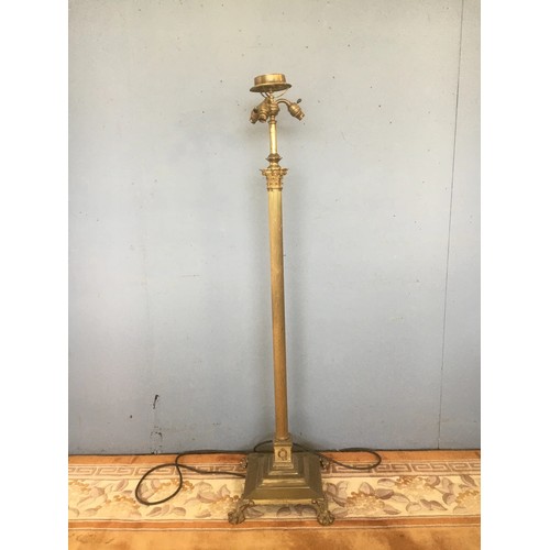 88 - A brass Standard Lamp with Corinthian Column, three bulb sockets and raised on square base with paw ... 