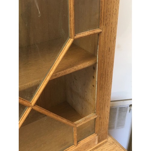 97 - An oak Bookcase, the upper section fitted two astragal glazed doors (one pane A/F) above base fitted... 