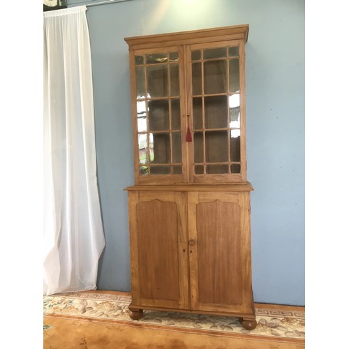 112 - A Victorian stripped mahogany Bookcase fitted  pair of glazed doors above base fitted two cupboard d... 