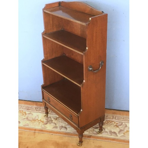 131 - A mahogany Waterfall Bookcase fitted single drawer raised on turned supports and brass casters 3ft 7... 