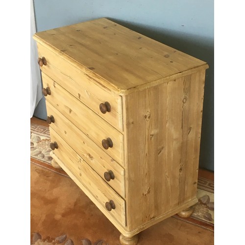 136 - A pine Chest of four long drawers raised on turned feet 2ft 10in W x 2ft 9in H x 1ft 6in D