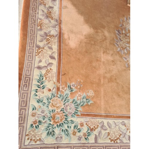 146 - A large Chinese style peach ground Carpet with central wreath of leaves 12ft 8in L x 9ft W