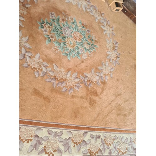 146 - A large Chinese style peach ground Carpet with central wreath of leaves 12ft 8in L x 9ft W