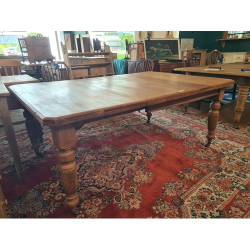 1 - An Edwardian walnut extending Dining Table with single spare leaf raised on fluted supports 5ft 10in... 