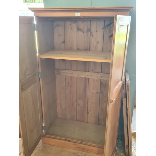 13 - A pine Housekeeper's Cupboard/Wardrobe fitted pair of panel doors on plinth base 5ft 5in H x 3ft 3in... 
