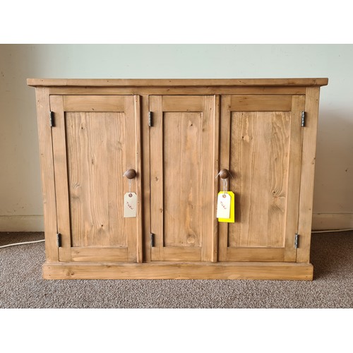 25 - A pine Cupboard fitted three panelled doors on plinth base 3ft 6in W x 2ft 6in H x 1ft 4in D