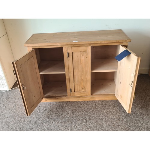 25 - A pine Cupboard fitted three panelled doors on plinth base 3ft 6in W x 2ft 6in H x 1ft 4in D