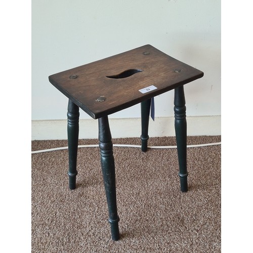 62 - An elm seated Stool on ebonised turned supports 1ft 6in H x 1ft 2in W x 10in D