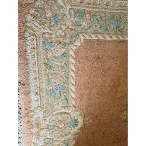 153 - A Chinese style apricot ground Rug A/F 10ft 4in L x 7ft W