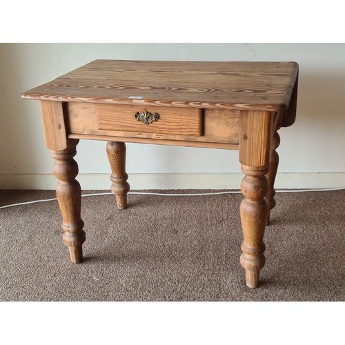 164 - A Victorian pitch pine Side Table with dropleaf fitted single frieze drawer raised on turned support... 