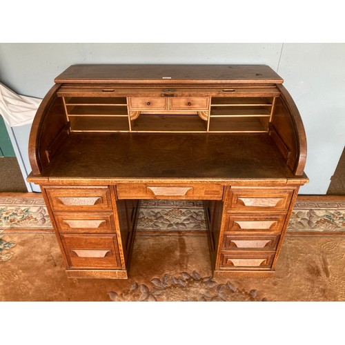 118 - An oak tambour front Desk with fitted interior of two drawers and shelves on pedestal bases, fitted ... 