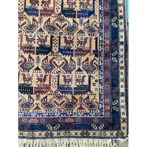 148 - A North African style woollen Rug with stylised bird design on brown ground within multiple borders ... 