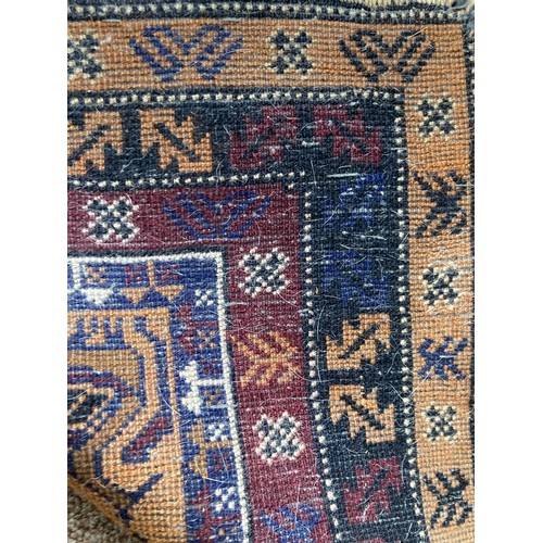 148 - A North African style woollen Rug with stylised bird design on brown ground within multiple borders ... 