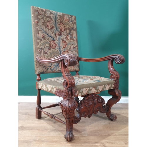 533 - A carved walnut Carolean style Throne Elbow Chair with floral upholstered back and seats, acanthus c... 