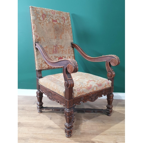 535 - A carved walnut Carolean style Throne Elbow Chair with floral upholstered back and seat, acanthus ca... 