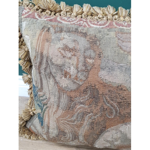 537 - An antique Tapestry Panel made into a cushion, decorated with cherub flanked by lion and griffin, an... 