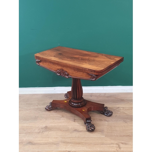 545 - An early 19th Century rosewood Tea Table with rectangular fold-over top raised on reeded baluster co... 