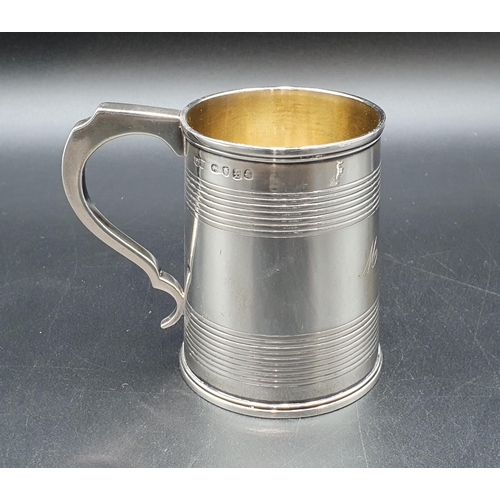 11 - A George IV silver Christening Mug of tapering form with reeded bands engraved initials M.A.C, Londo... 