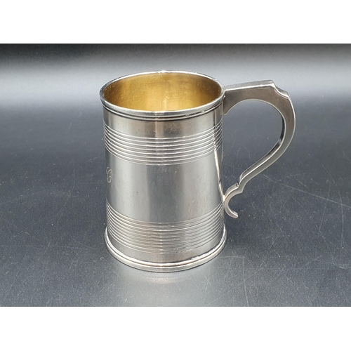 11 - A George IV silver Christening Mug of tapering form with reeded bands engraved initials M.A.C, Londo... 