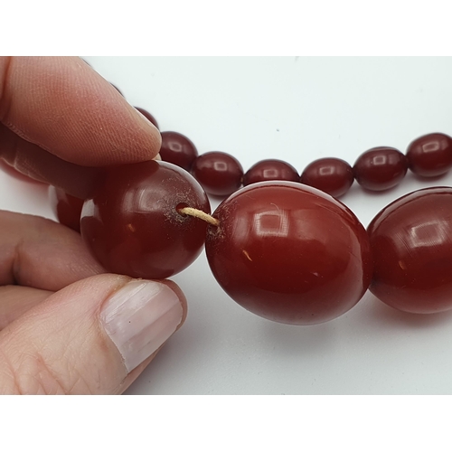 144 - A string of Cherry red Bakelite graduated Beads, approx 93gms, largest bead approx 21.40mm diameter,... 