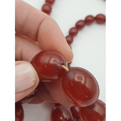 144 - A string of Cherry red Bakelite graduated Beads, approx 93gms, largest bead approx 21.40mm diameter,... 