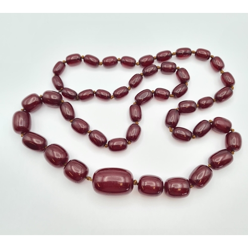 145 - A string of Cherry red Bakelite graduated Beads, approx 126gms, largest bead approx 24mm diameter, s... 