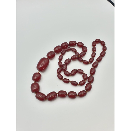 145 - A string of Cherry red Bakelite graduated Beads, approx 126gms, largest bead approx 24mm diameter, s... 