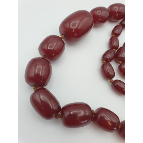 145 - A string of Cherry red Bakelite graduated Beads, approx 126gms, largest bead approx 24mm diameter, s... 