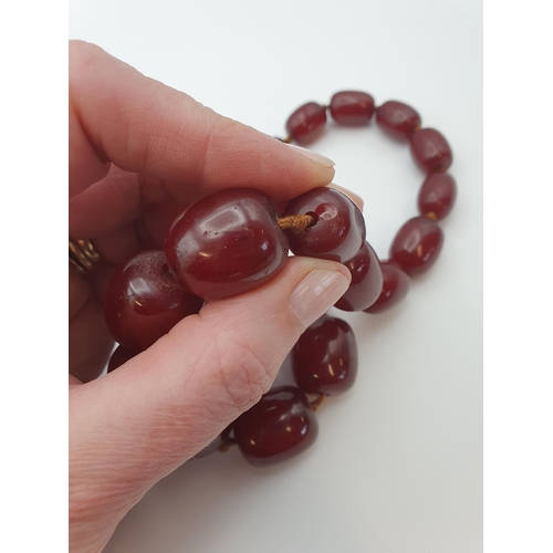 145 - A string of Cherry red Bakelite graduated Beads, approx 126gms, largest bead approx 24mm diameter, s... 