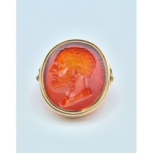 159 - A gold swivel Intaglio Seal/Ring set carnelian carved classical bust and engraved Greek script, unma... 