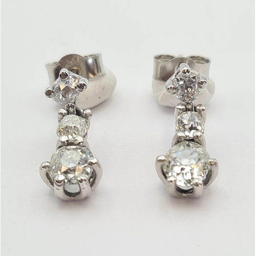 171 - A pair of diamond drop Earrings each claw-set three graduated old-cut stones in platinum, estimated ... 