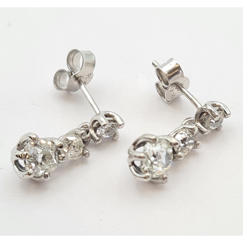 171 - A pair of diamond drop Earrings each claw-set three graduated old-cut stones in platinum, estimated ... 