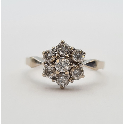 178 - A Diamond flower Cluster Ring claw-set seven brilliant-cut stones in 18ct gold, ring size O, approx ... 