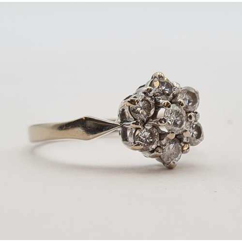 178 - A Diamond flower Cluster Ring claw-set seven brilliant-cut stones in 18ct gold, ring size O, approx ... 