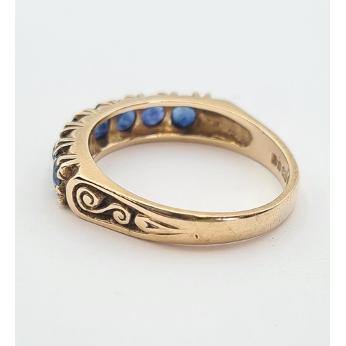 181 - A Sapphire half Eternity Ring set seven round stones in 9ct gold, ring size M 1/2, approx 3gms