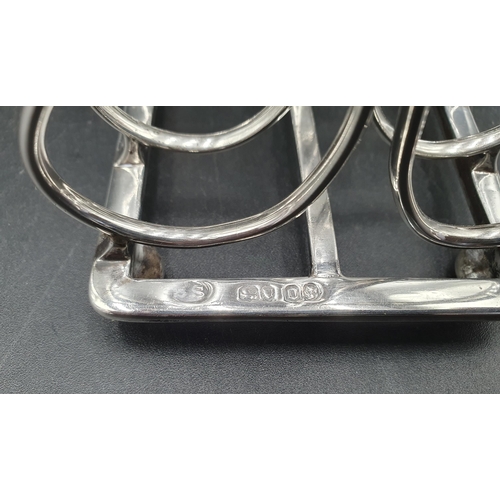 2 - A Victorian silver five bar Toastrack with central handle engraved crest, on bun feet, London 1869, ... 