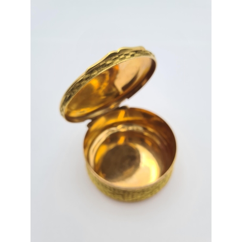 225 - A circular gold plated Trinket Box with basket weave effect and hinged lid, approx 7cms diameter