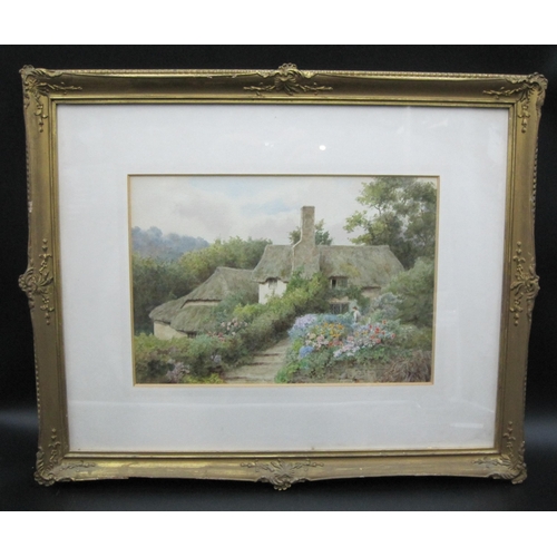 289 - THOMAS NICHOLSON TYNDALE (1860-1930). In a Cottage Garden, signed, watercolour, 9 x 13 in